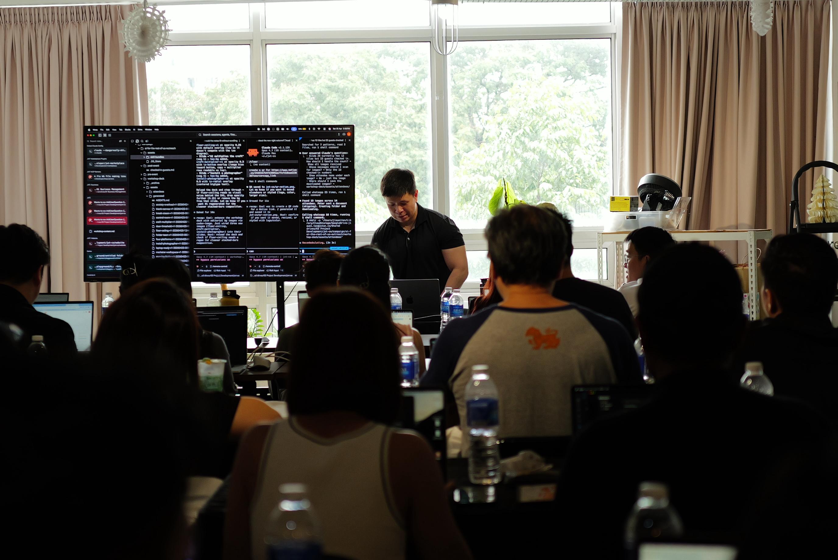 Jia Wei presenting at the AI for the Rest of Us workshop in KL, attendees following along on laptops