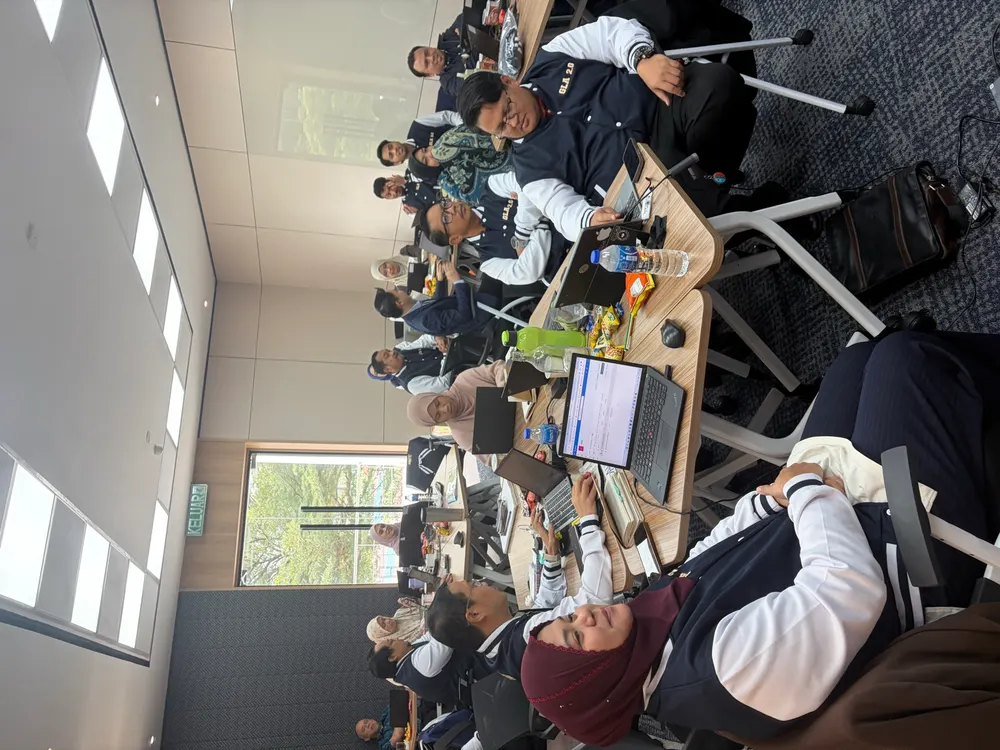TNB participants at laptops, smiling mid-exercise