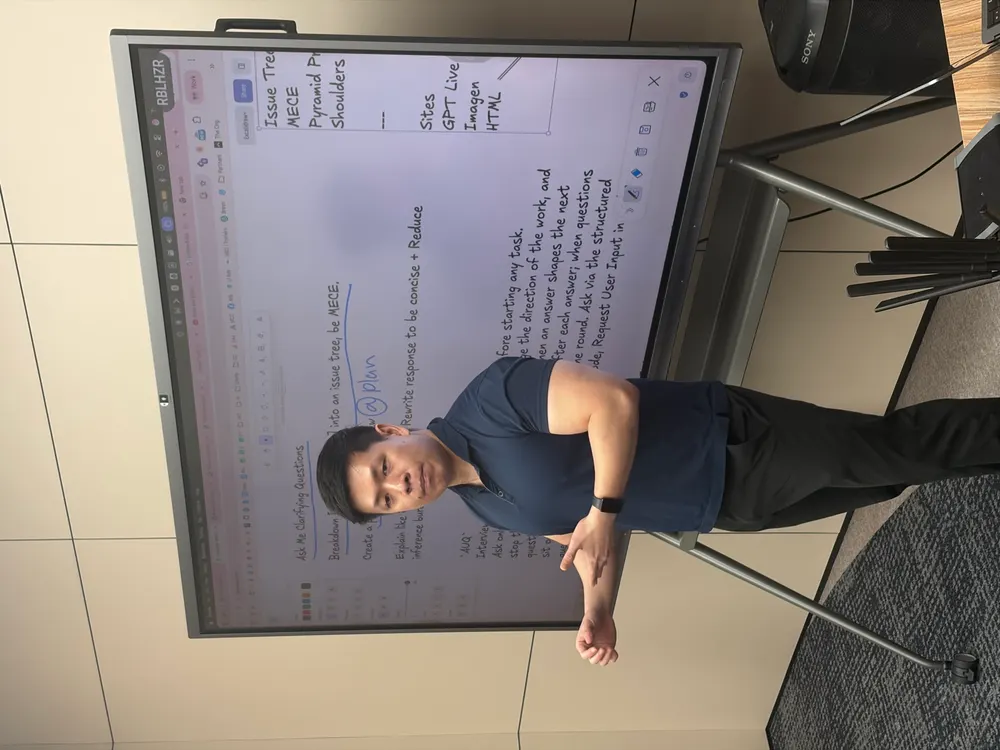 Jia Wei explaining a workflow beside annotated notes on screen
